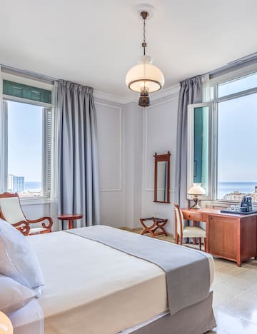 a bedroom with a bed and a desk and chair