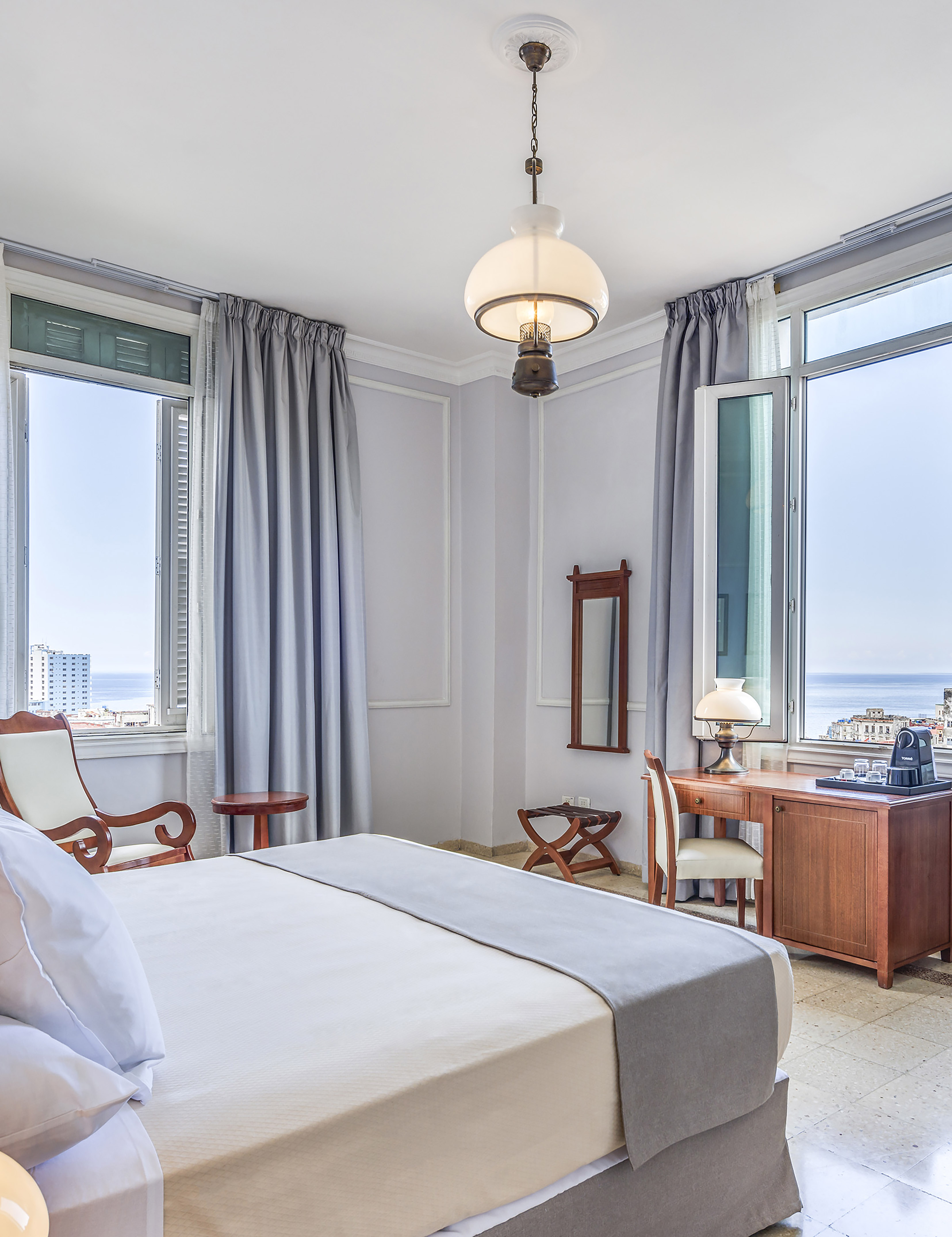 a bedroom with a bed and a desk and chair