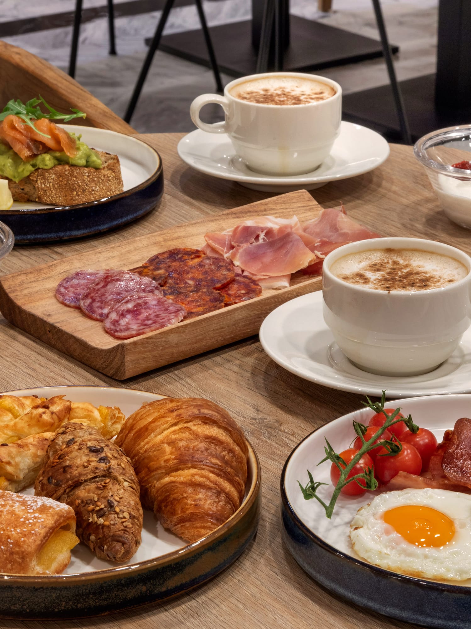 Variado desayuno: café, huevos, tocino, bollería, fruta, tostada, embutidos