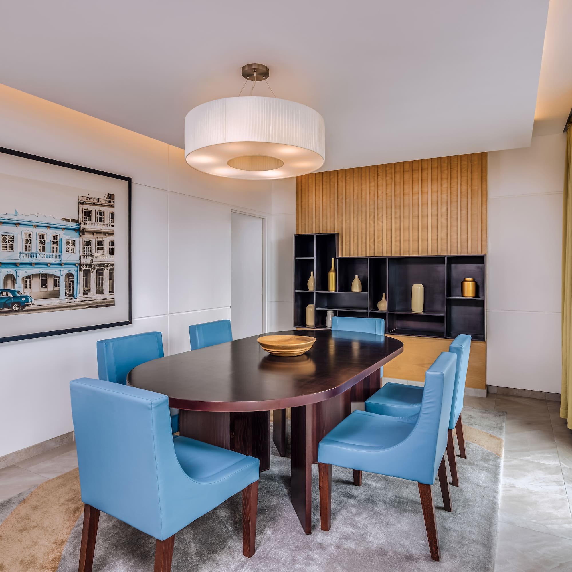 a dining room with a table and blue chairs
