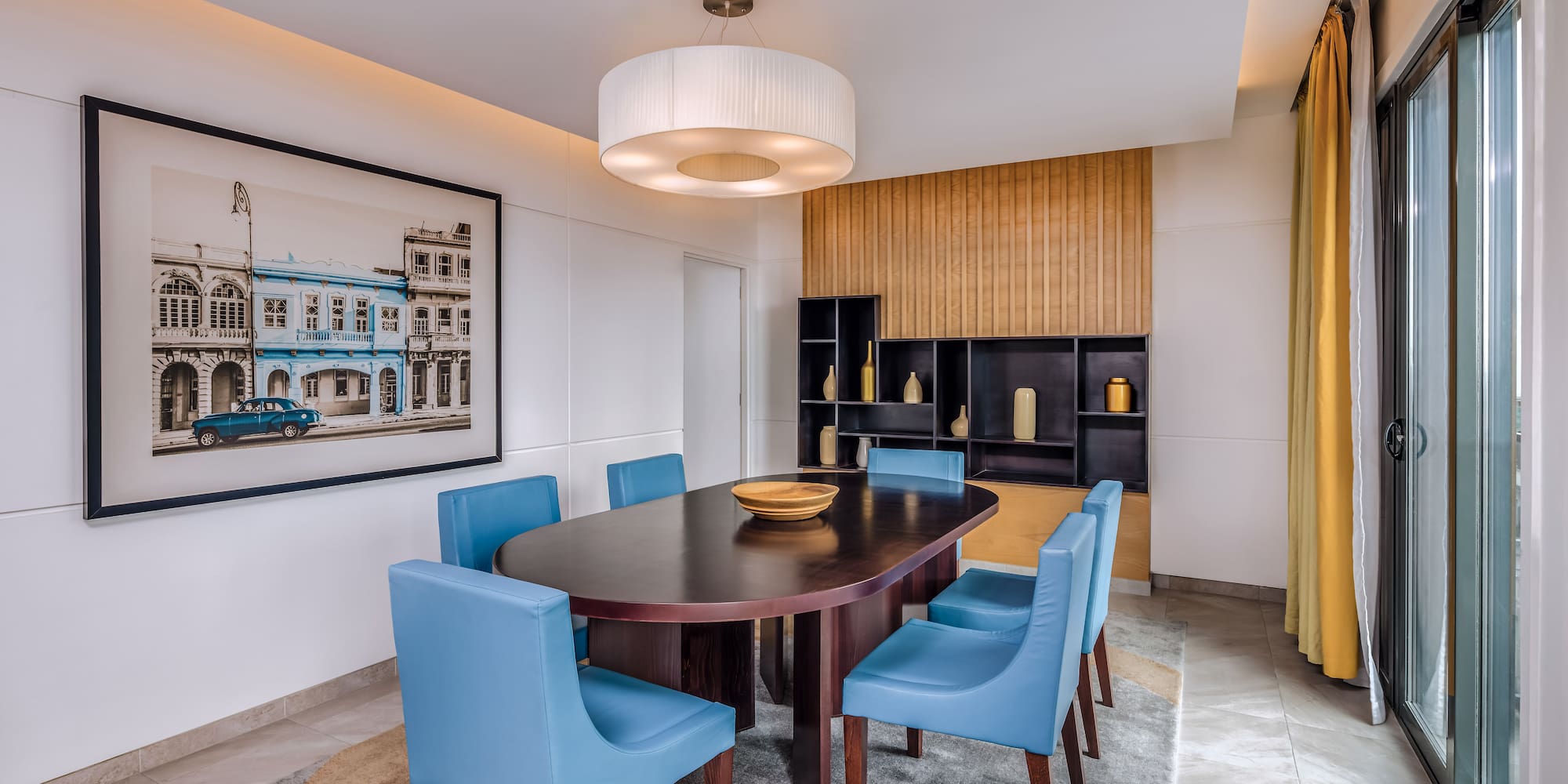 a dining room with a table and blue chairs