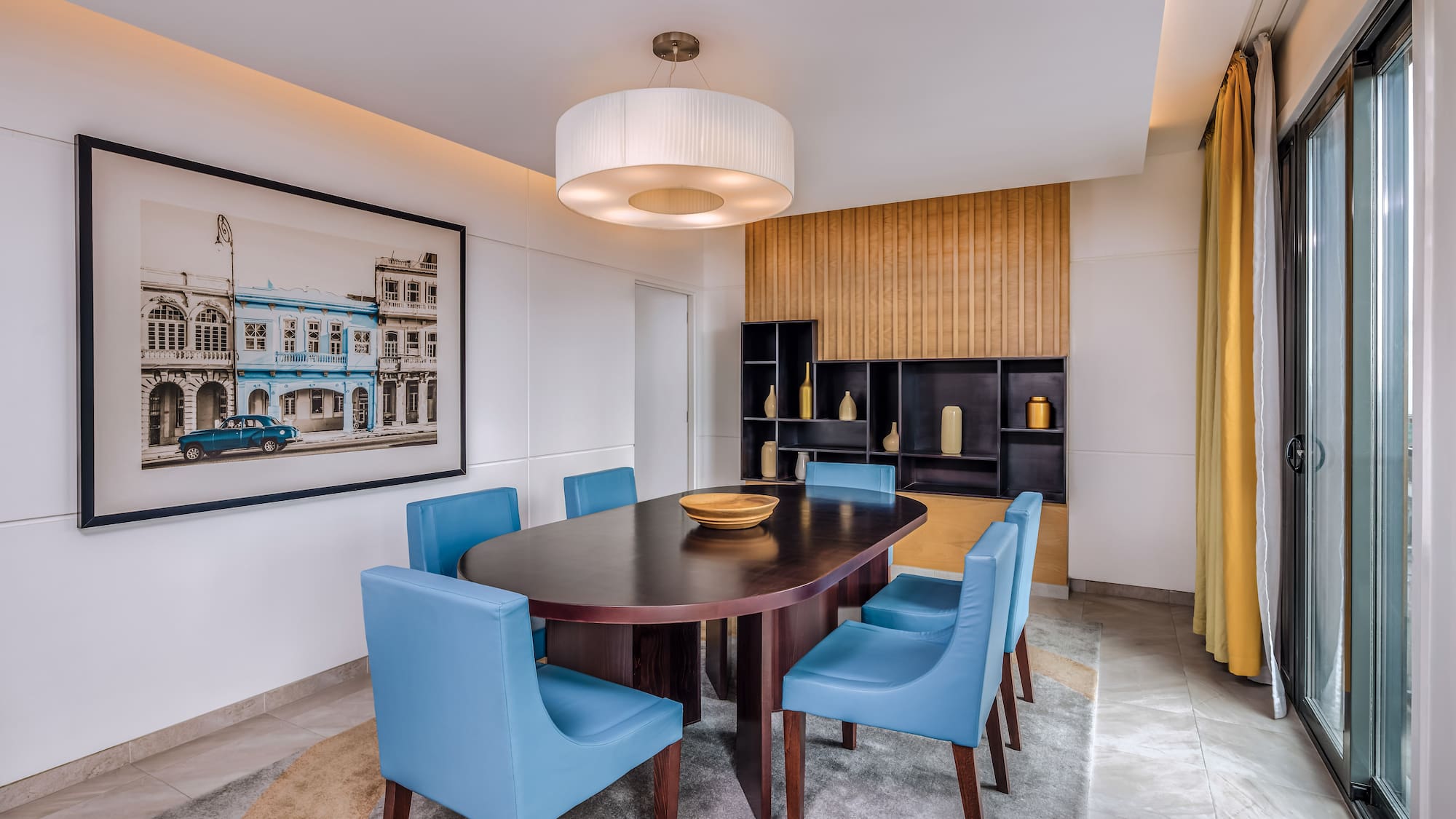 a dining room with a table and blue chairs