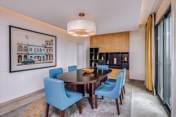 a dining room with a table and blue chairs