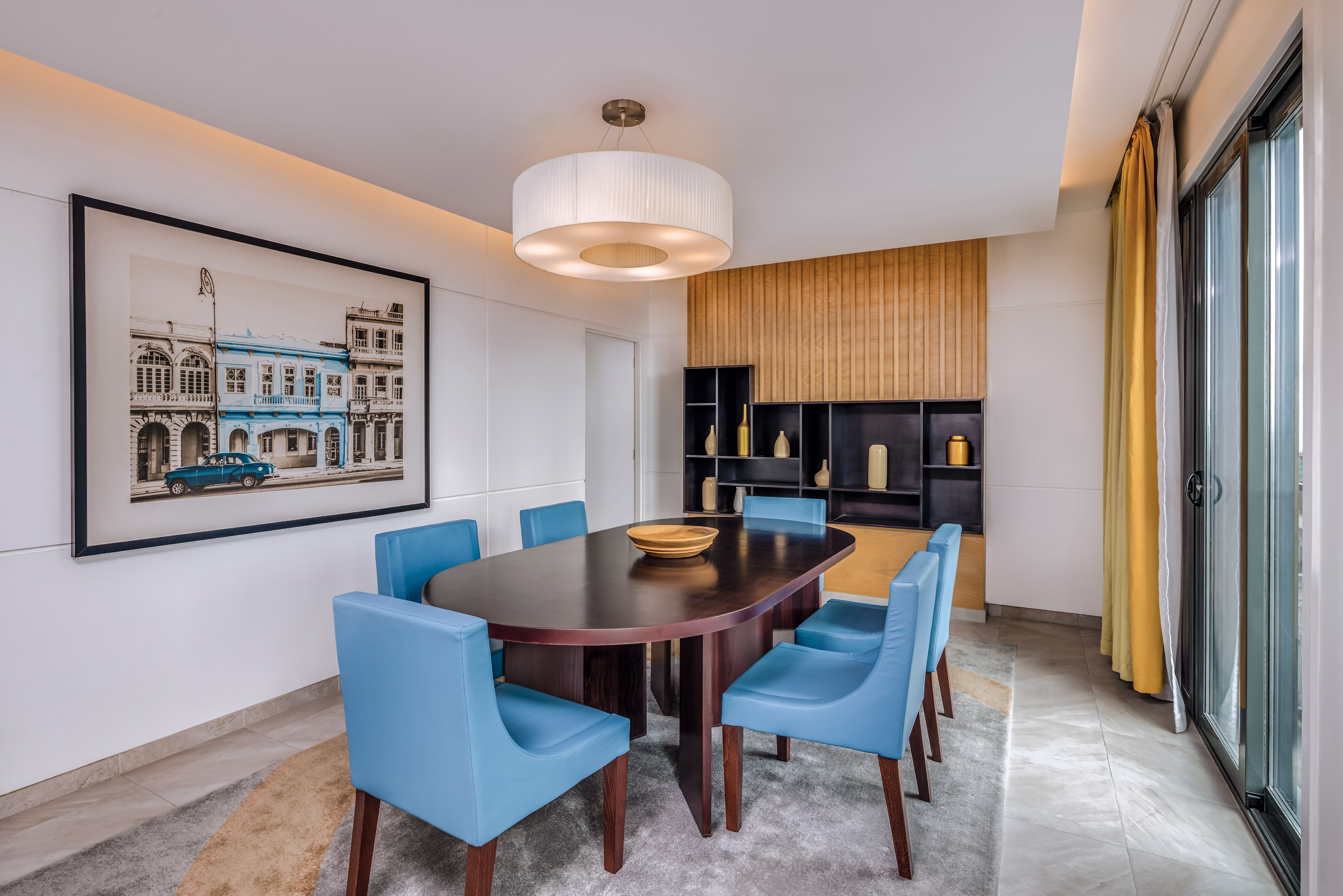 a dining room with a table and blue chairs