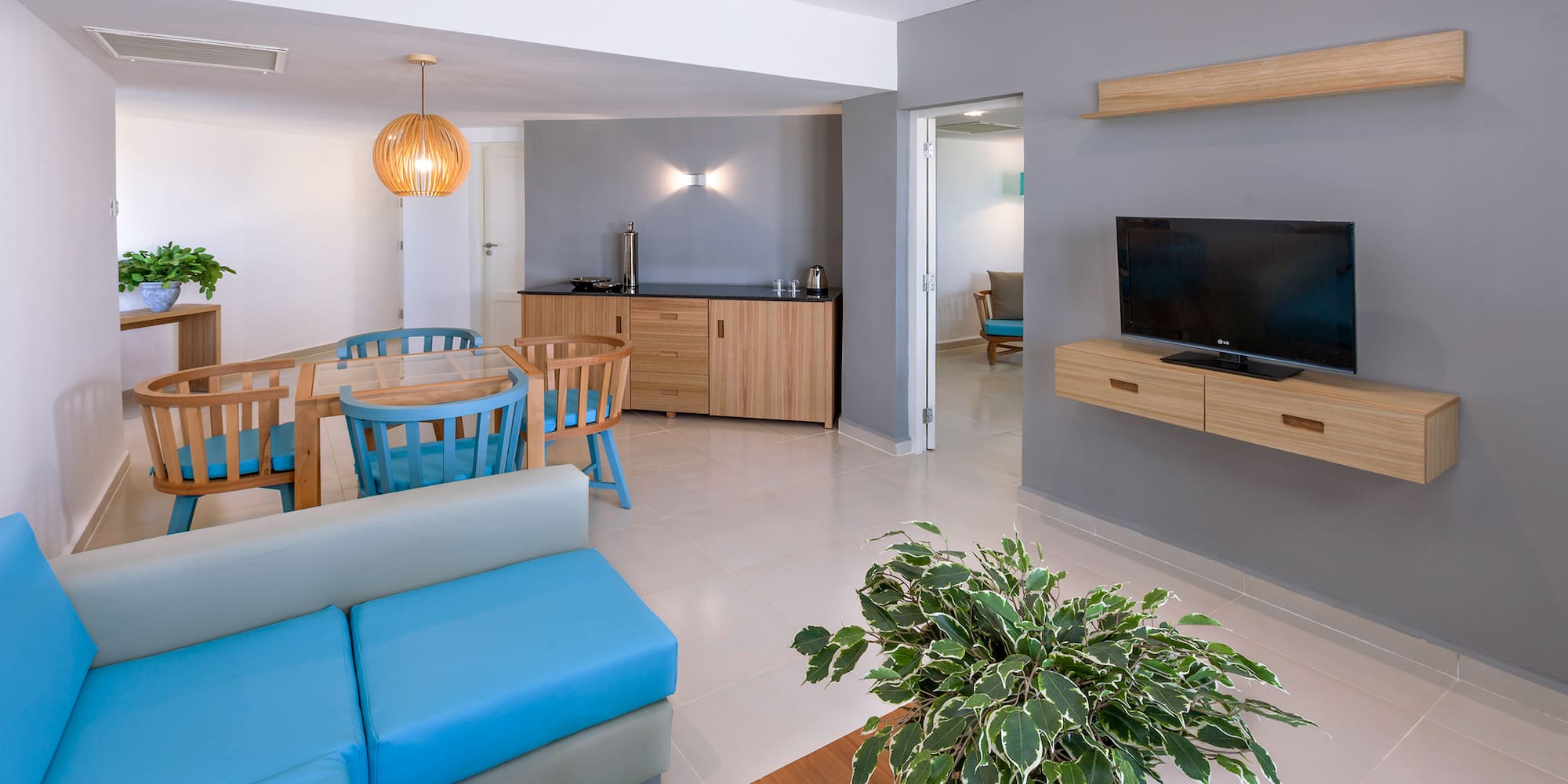 a living room with a blue couch and a tv