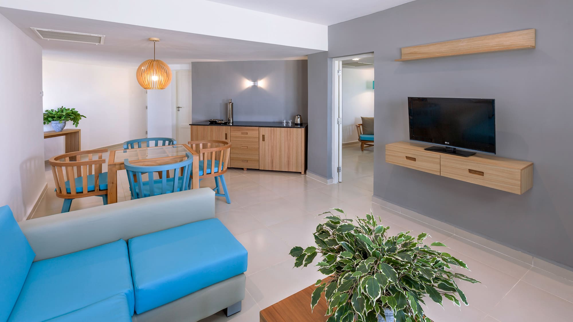 a living room with a blue couch and a tv