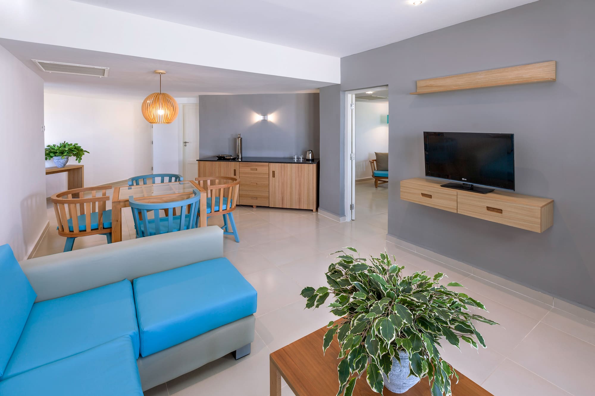 a living room with a blue couch and a tv
