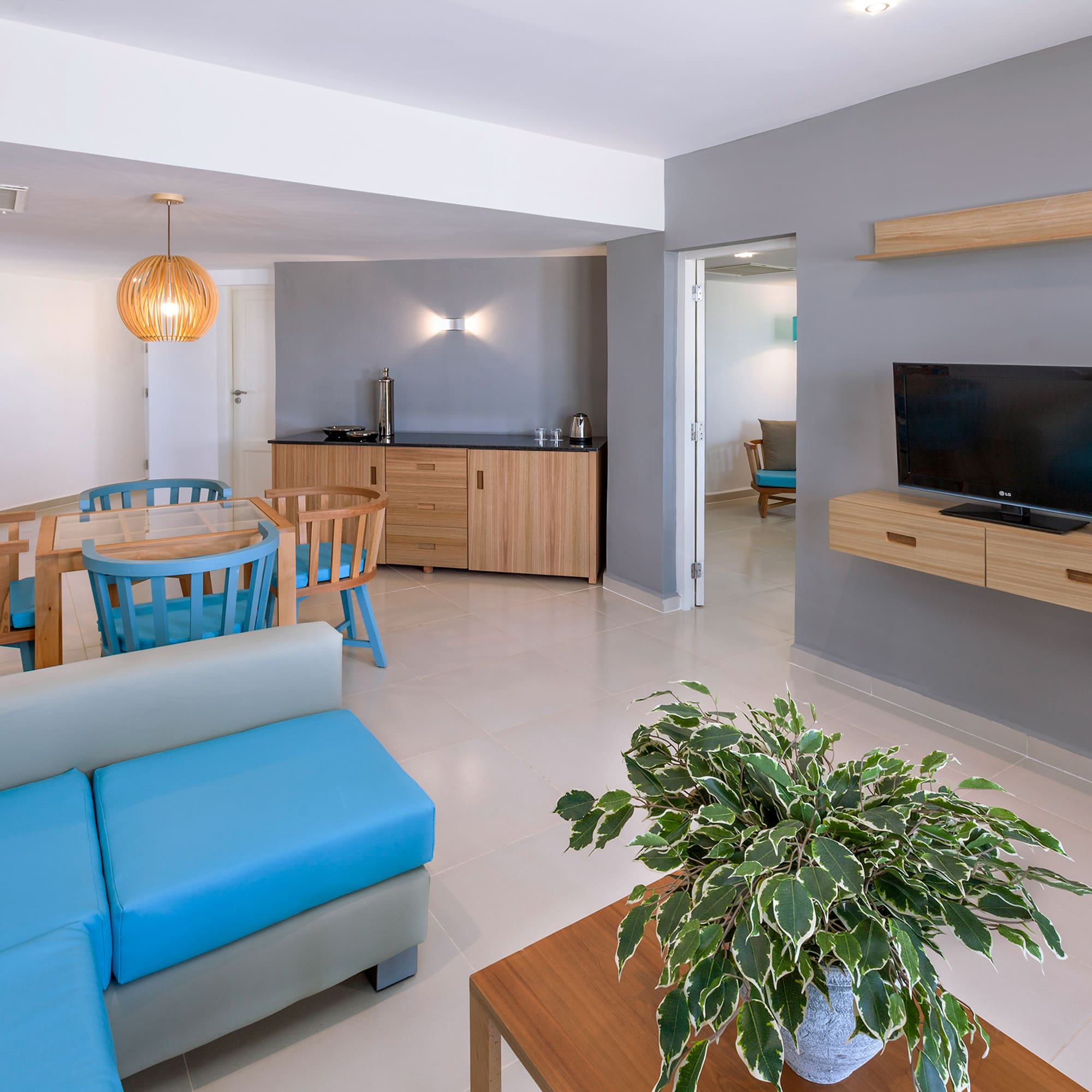 a living room with a blue couch and a tv