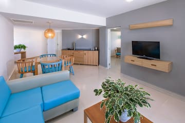 a living room with a blue couch and a tv