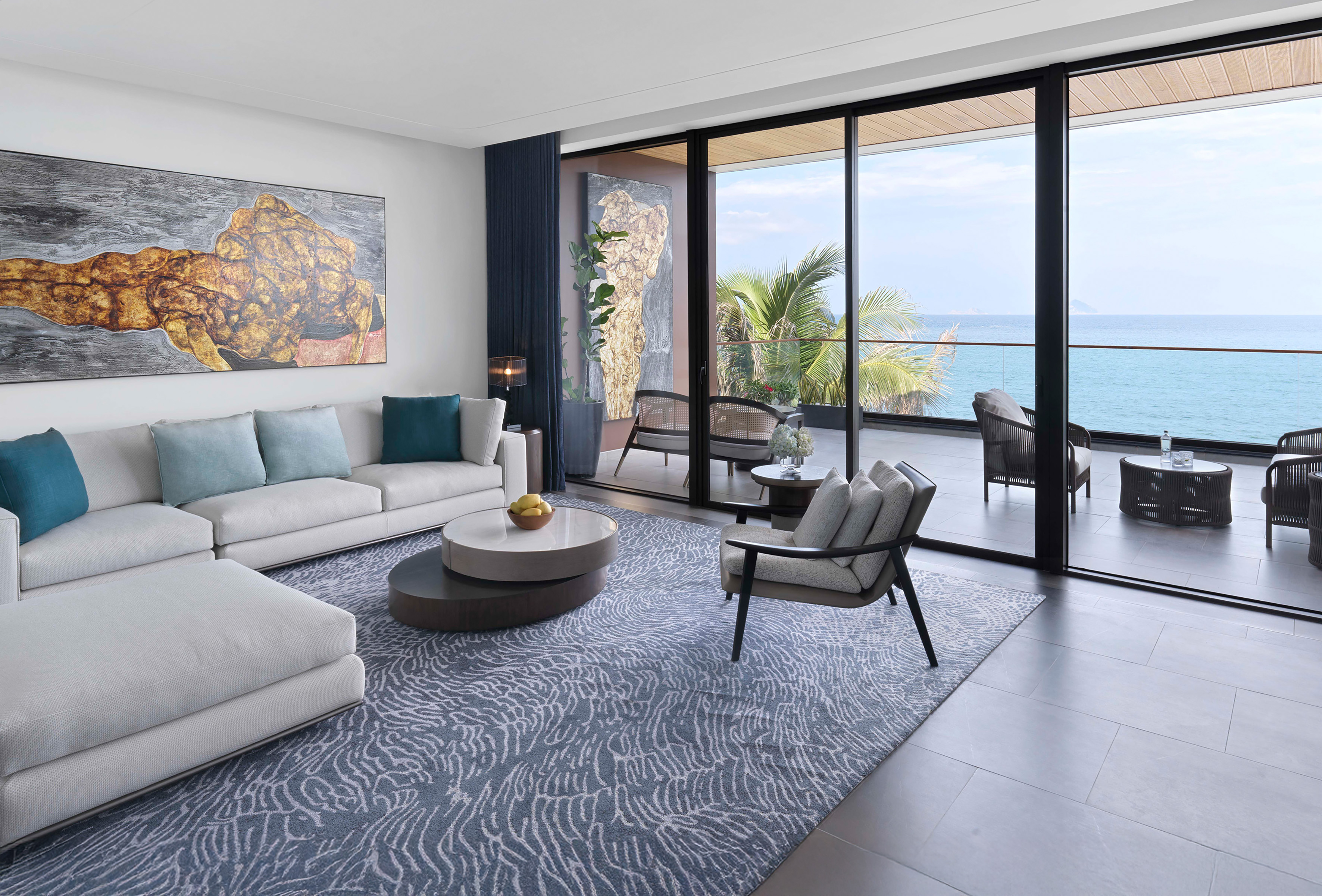 a living room with a view of the ocean