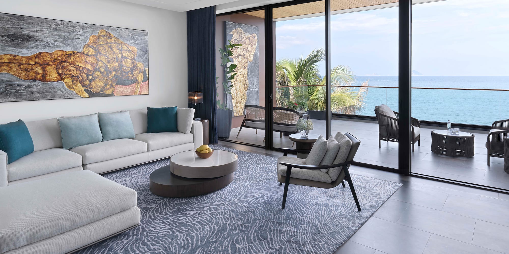 a living room with a view of the ocean