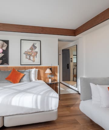 a bedroom with a bed and couches