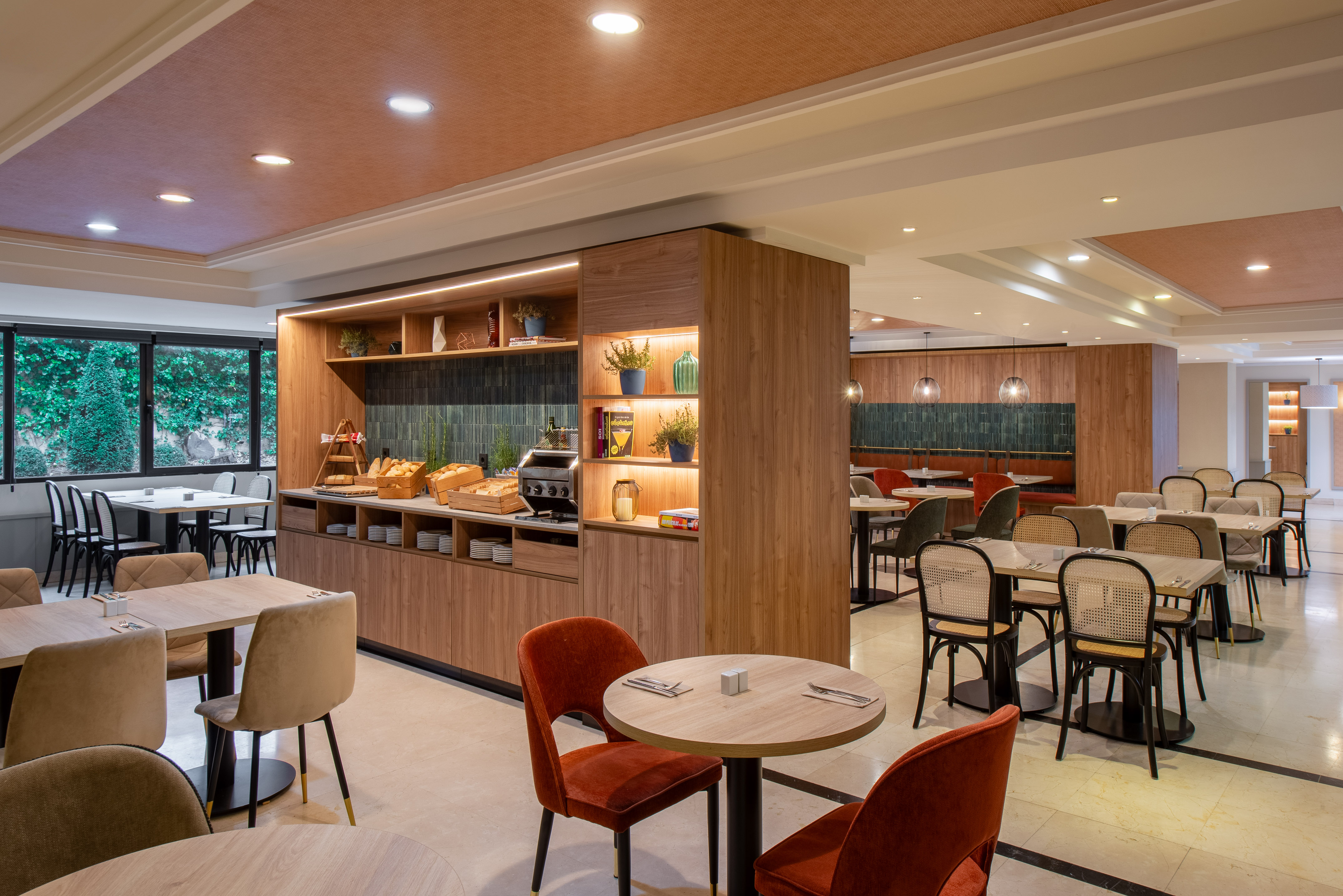 Contemporary hotel breakfast room interior with buffet and stylish seating.
