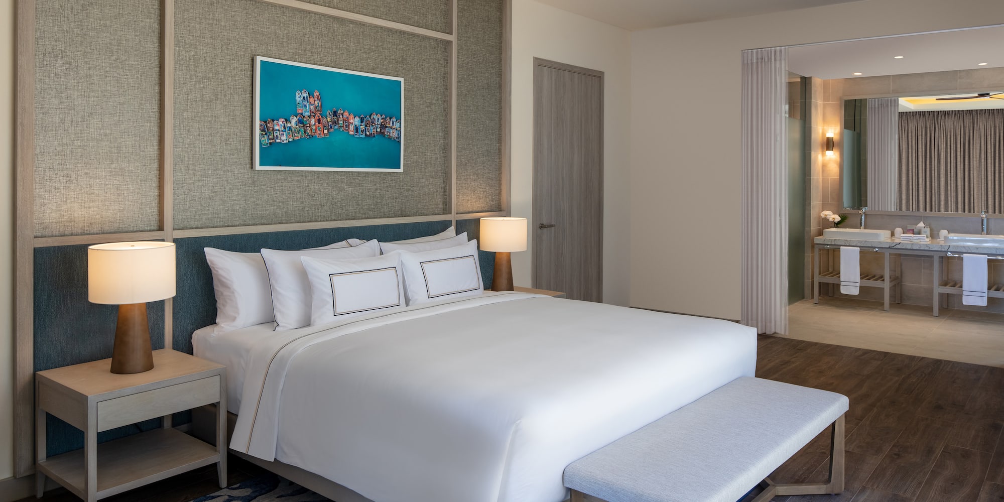 a bedroom with a bed and a painting on the wall