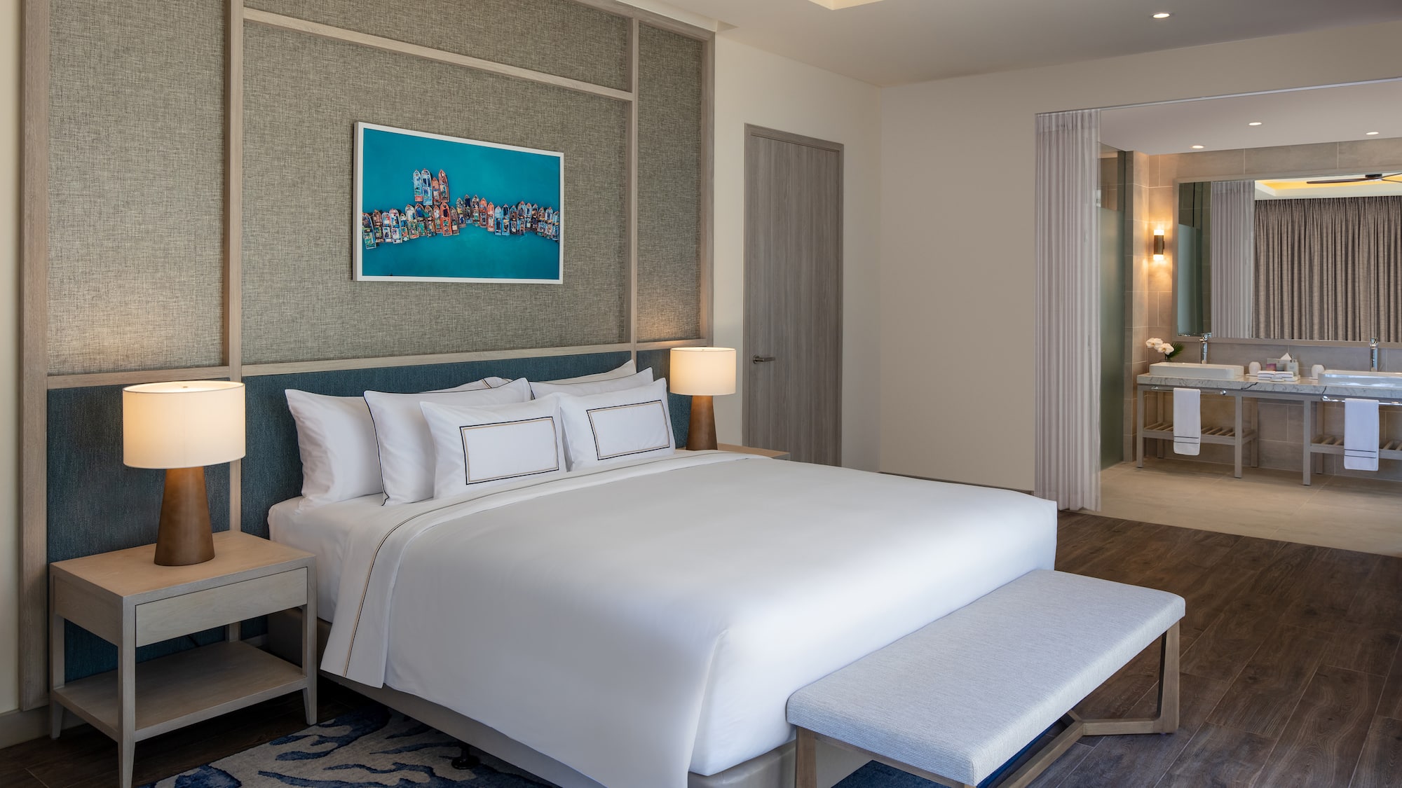 a bedroom with a bed and a painting on the wall