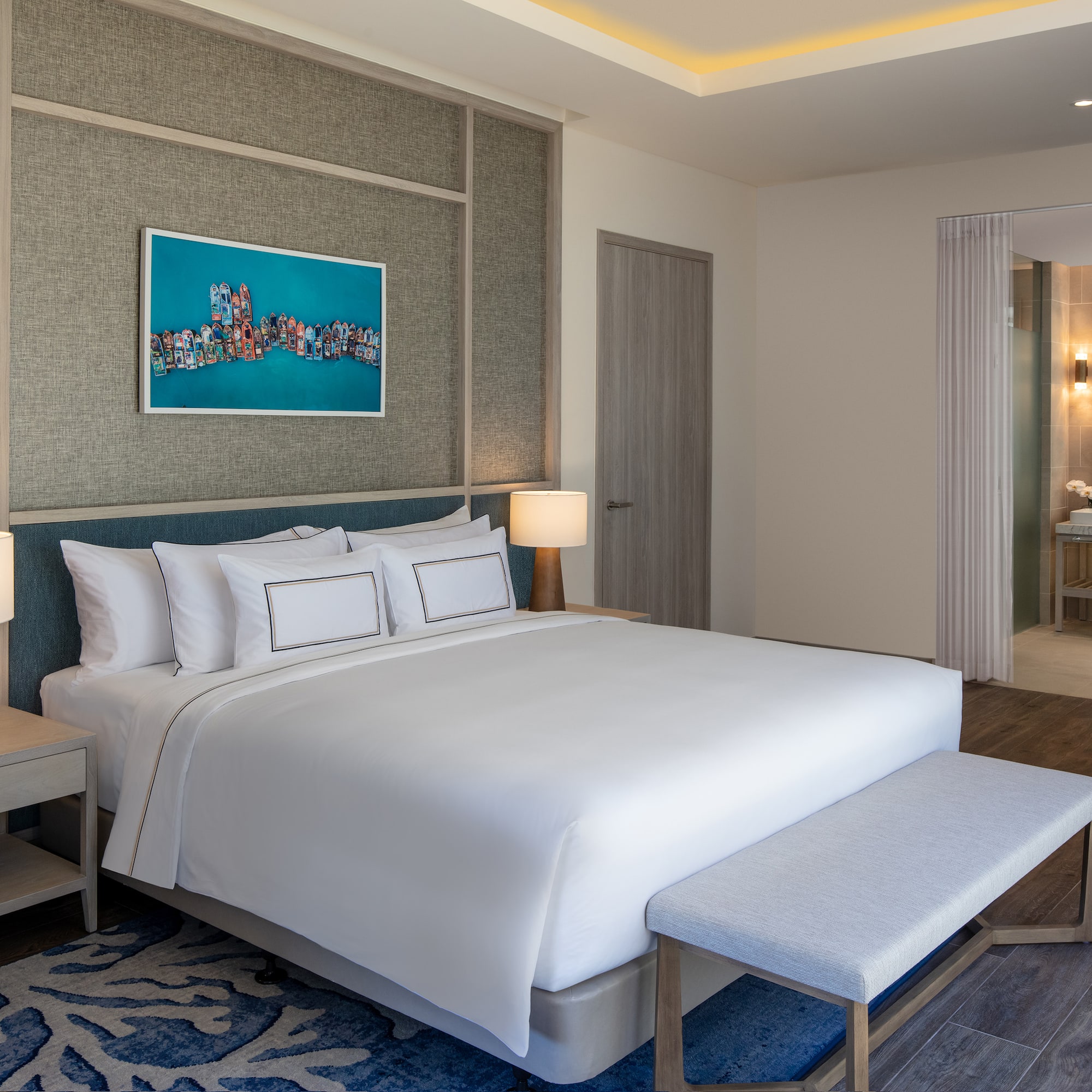 a bedroom with a bed and a painting on the wall