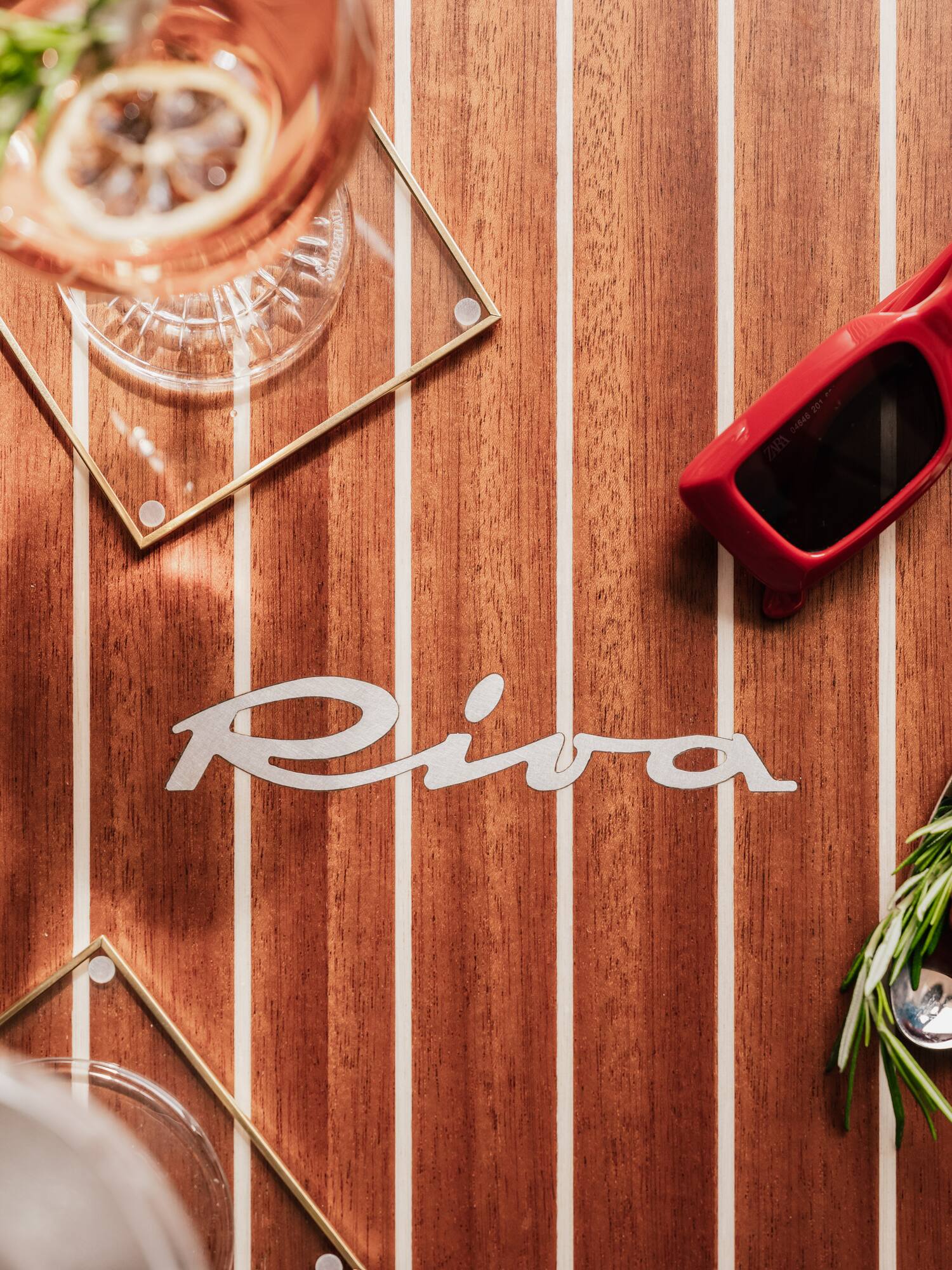 a table with a glass and a drink