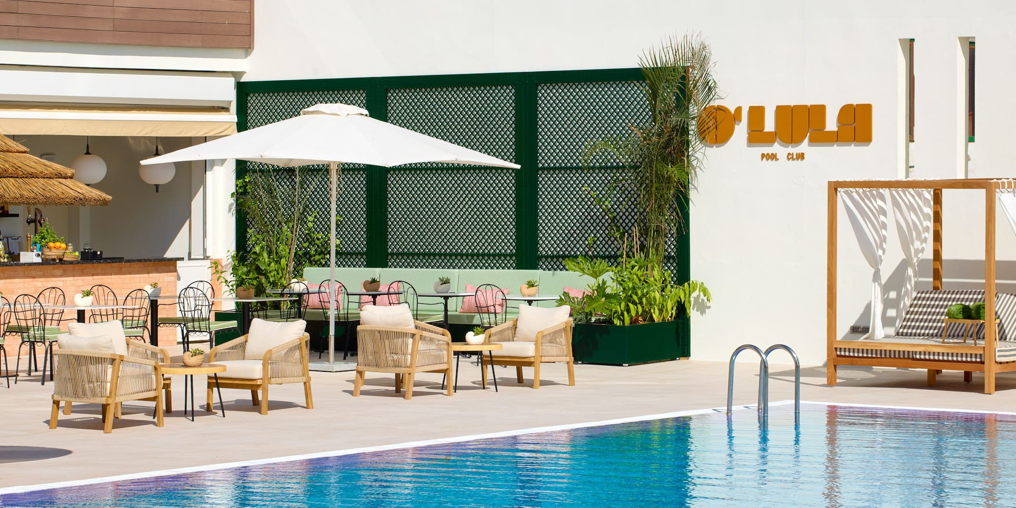 a pool with chairs and umbrellas
