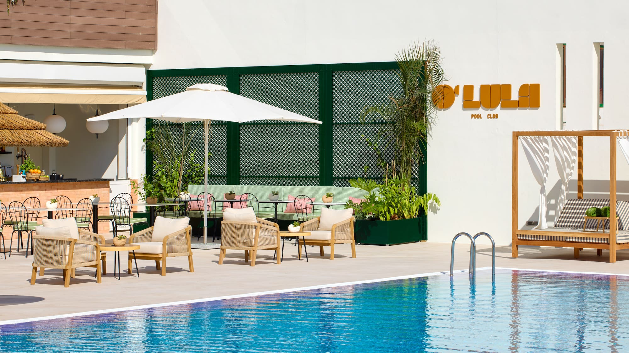 a pool with chairs and umbrellas