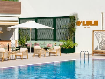 a pool with chairs and umbrellas