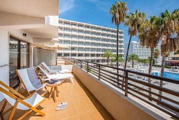 a deck with chairs and palm trees