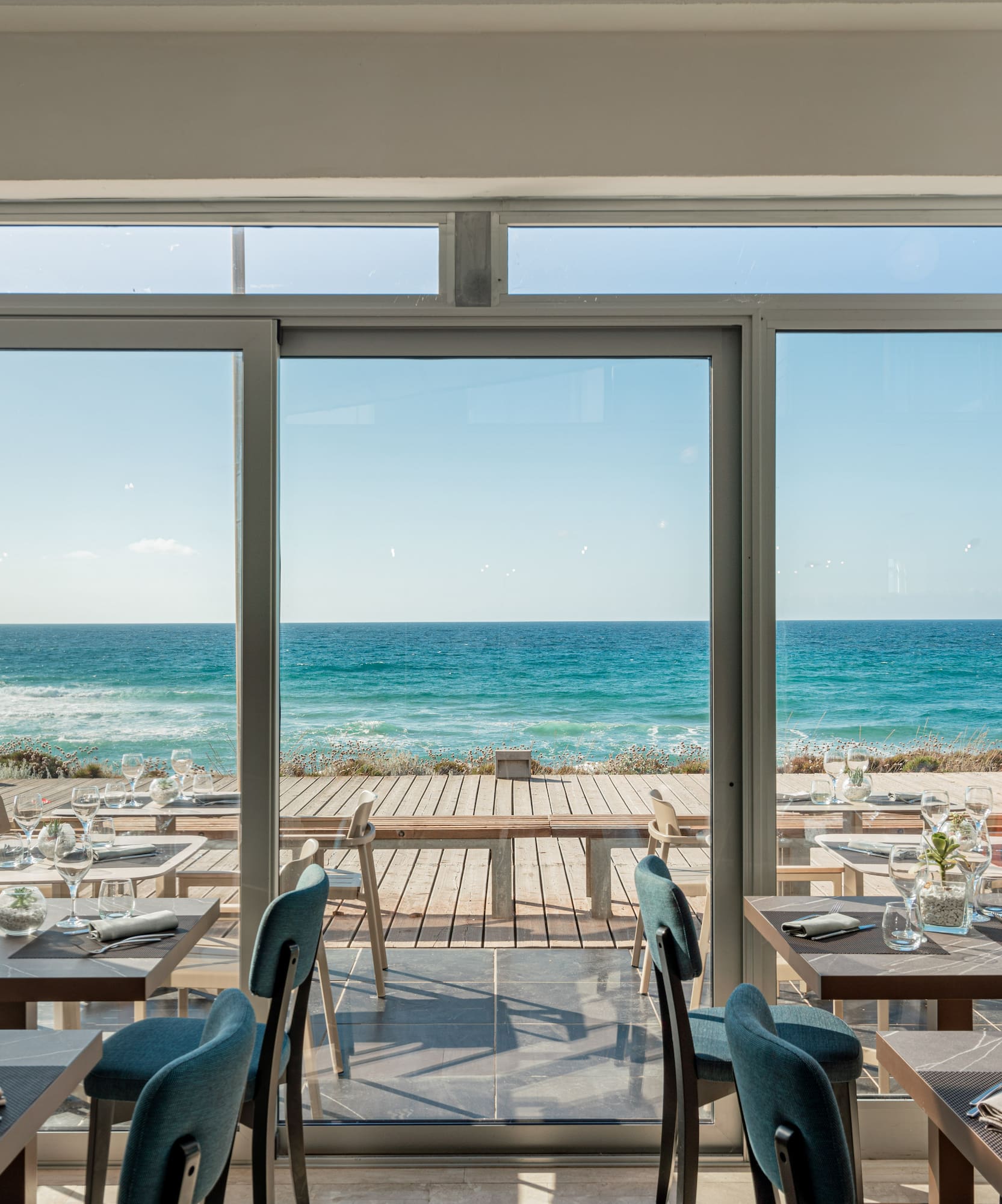 a restaurant with tables and chairs on a beach