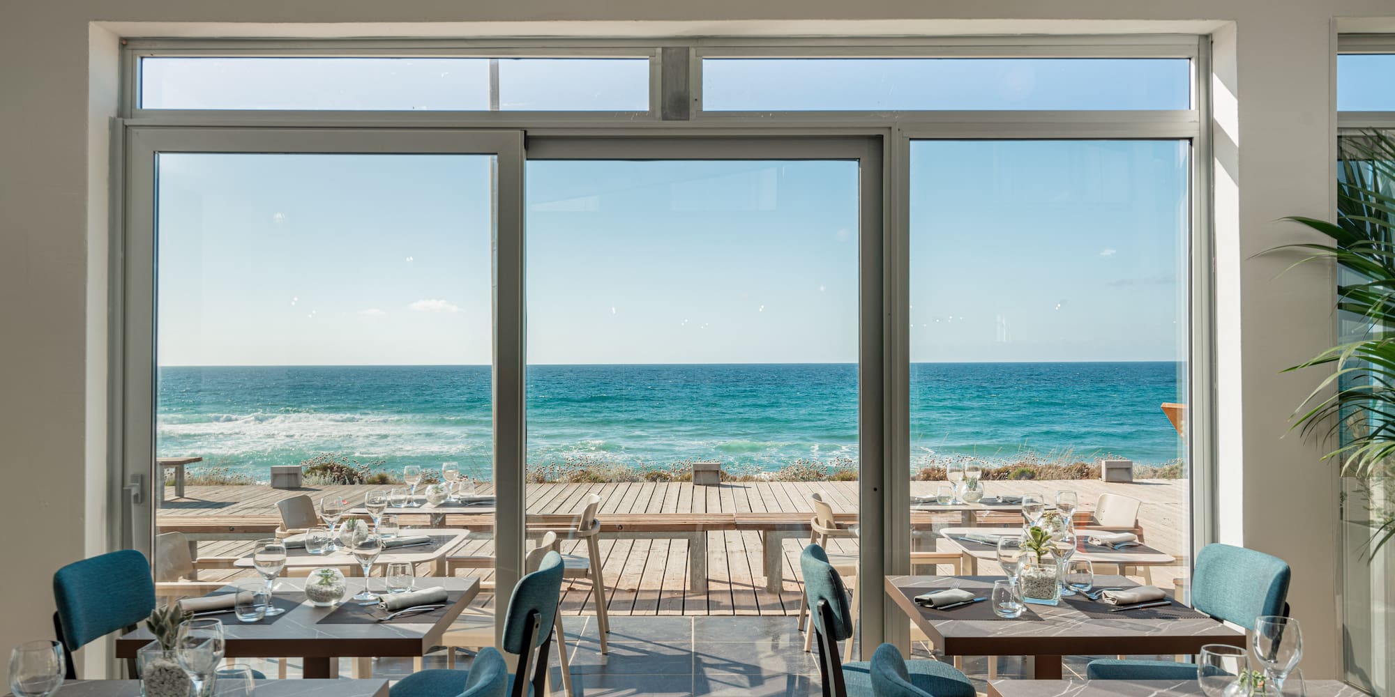 a restaurant with tables and chairs on a beach