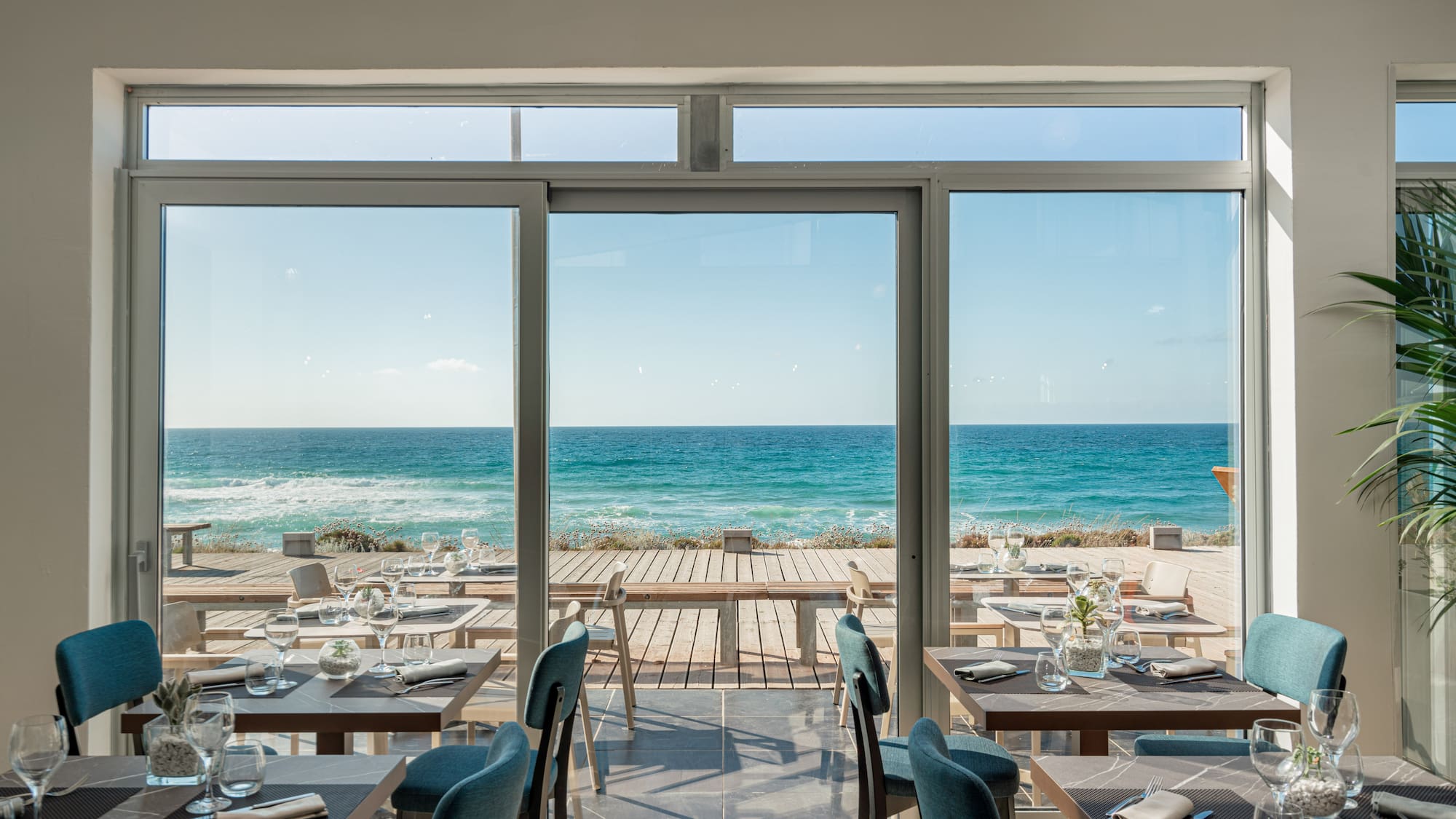 a restaurant with tables and chairs on a beach
