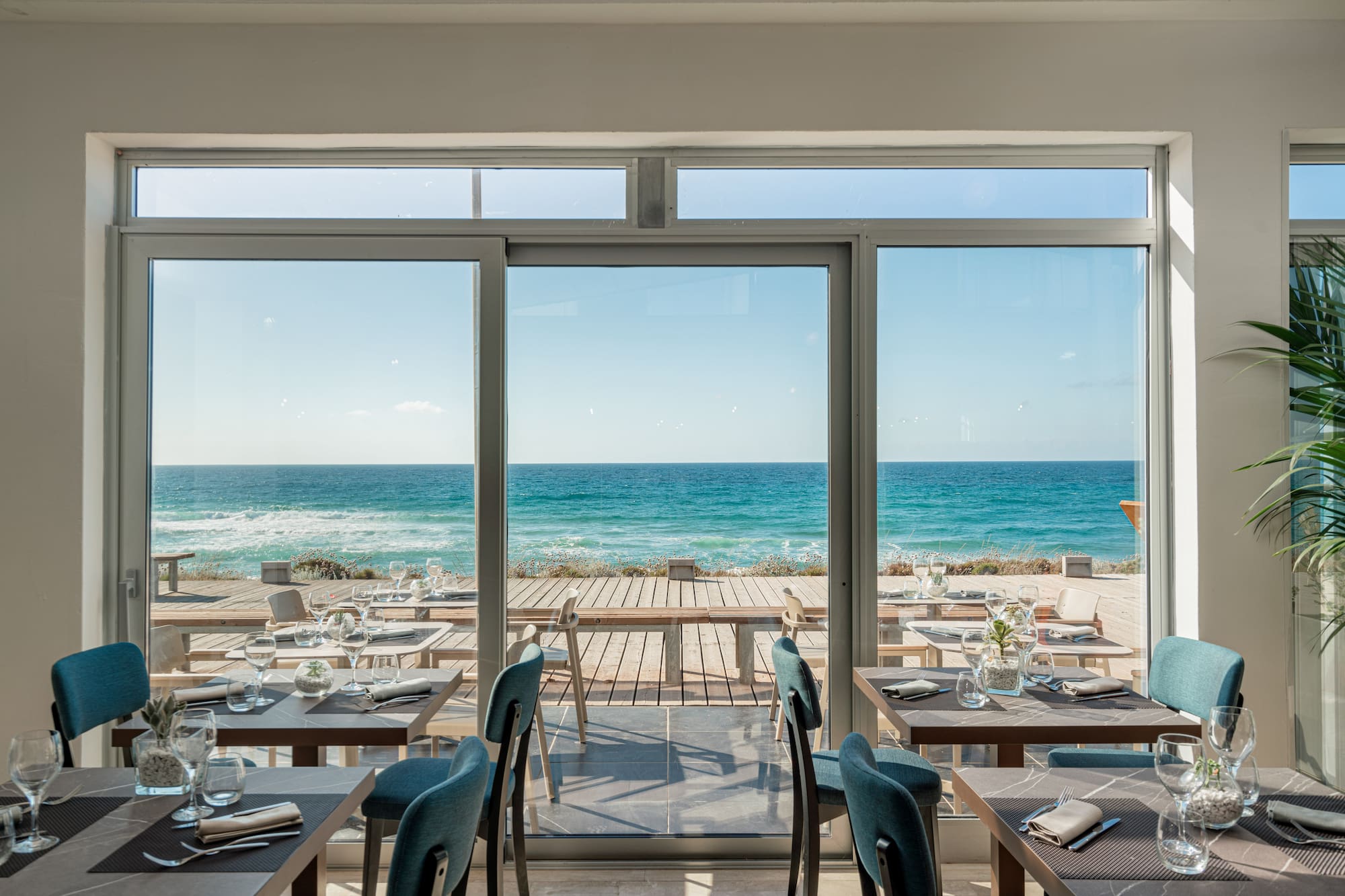 a restaurant with tables and chairs on a beach