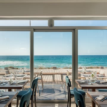 a restaurant with tables and chairs on a beach