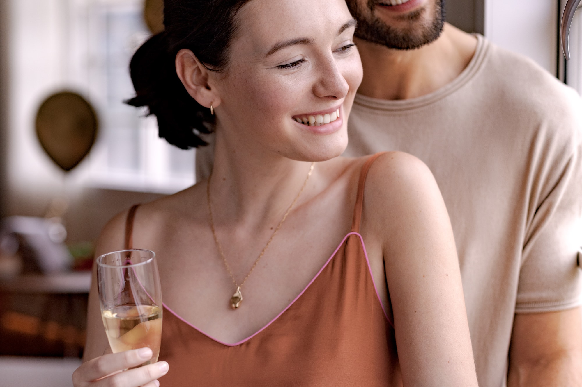 a man and woman holding wine glasses
