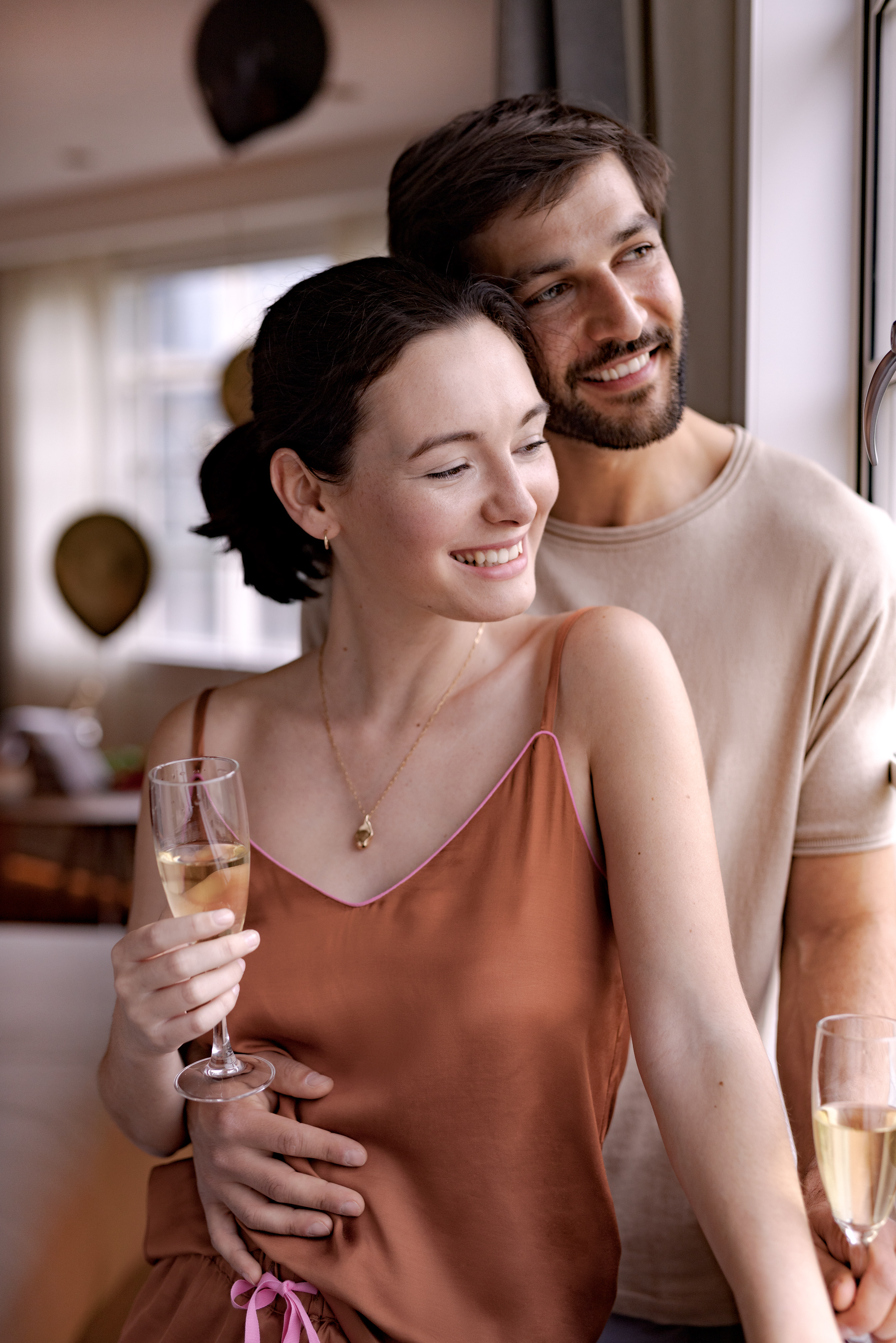 a man and woman holding wine glasses