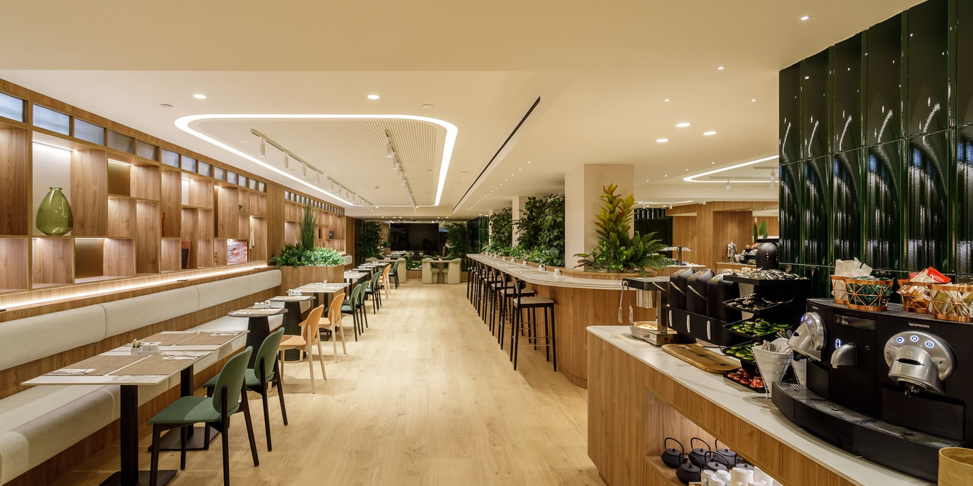 Modern dining room with wood decor, booth seating, and well-stocked coffee bar.