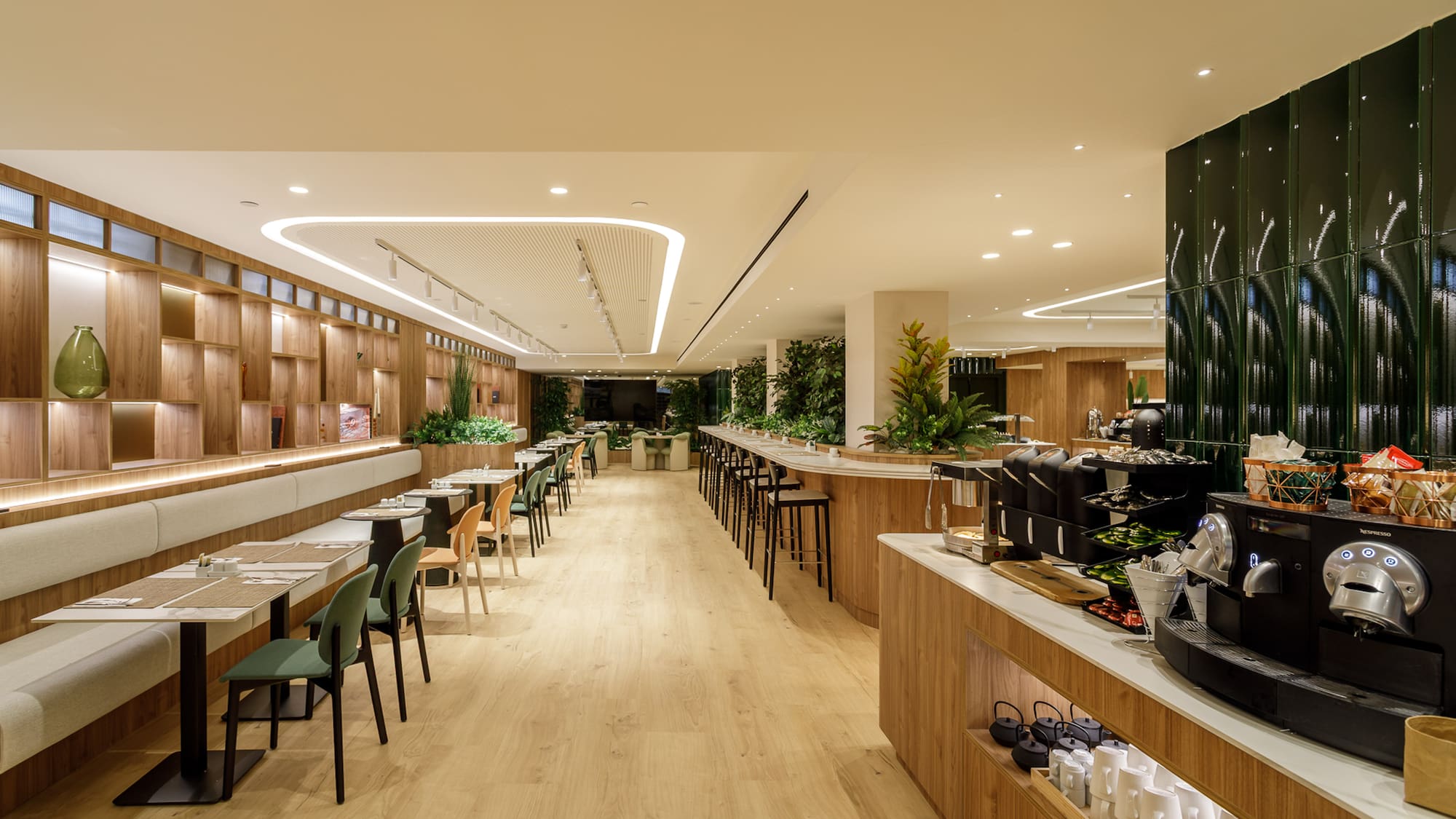 Modern dining room with wood decor, booth seating, and well-stocked coffee bar.
