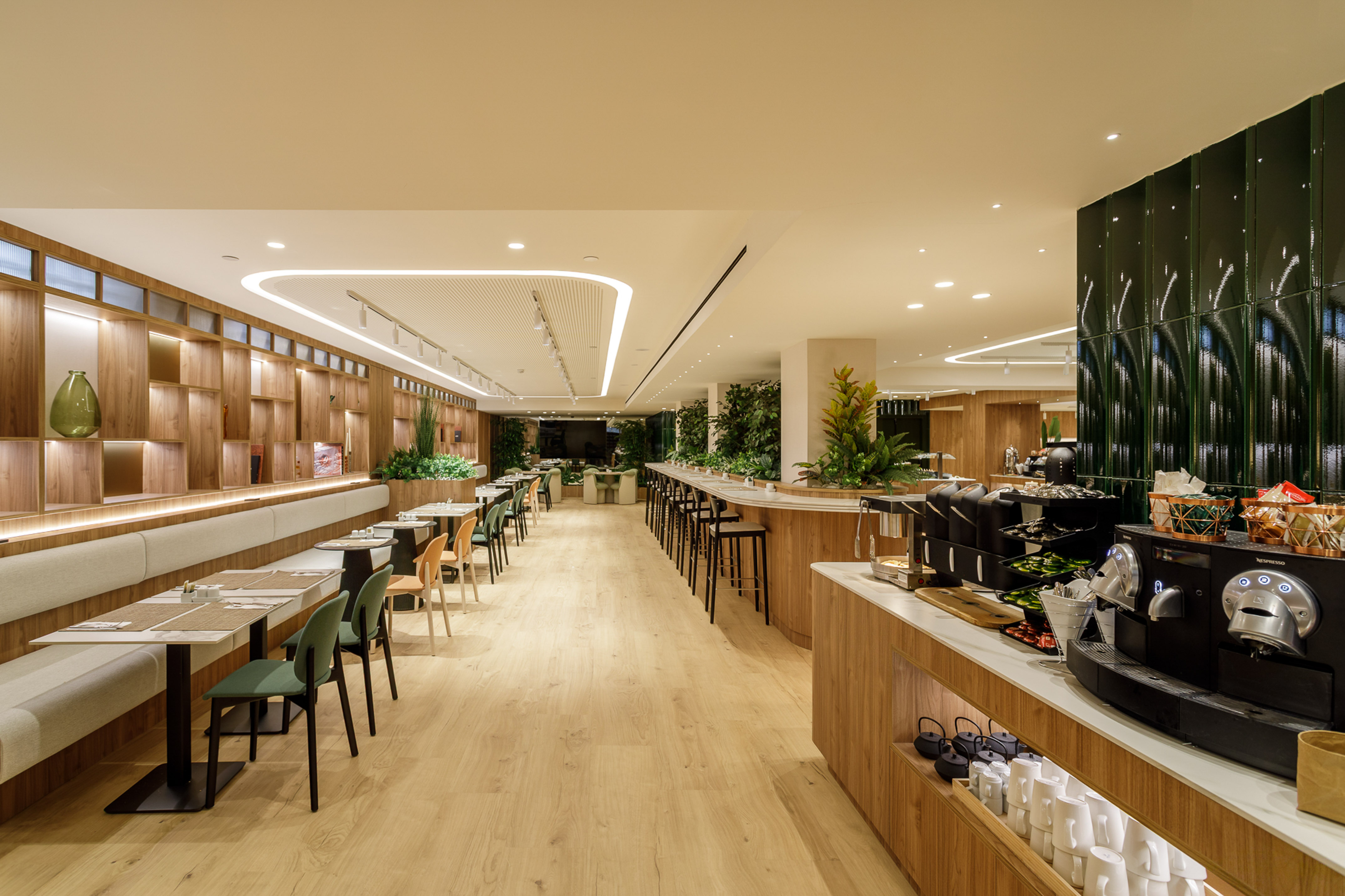 Modern dining room with wood decor, booth seating, and well-stocked coffee bar.