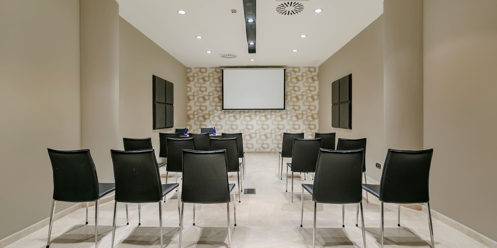 a room with chairs and a projector screen