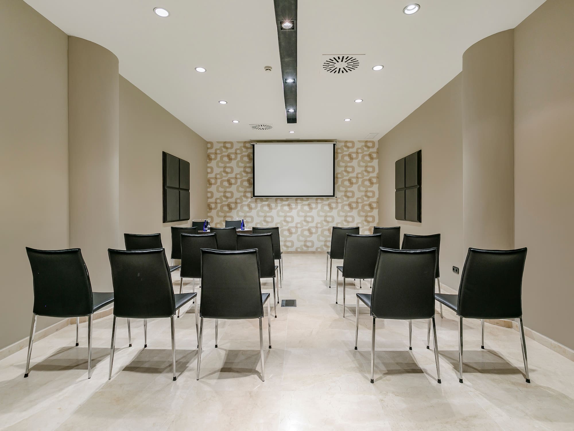 a room with chairs and a projector screen