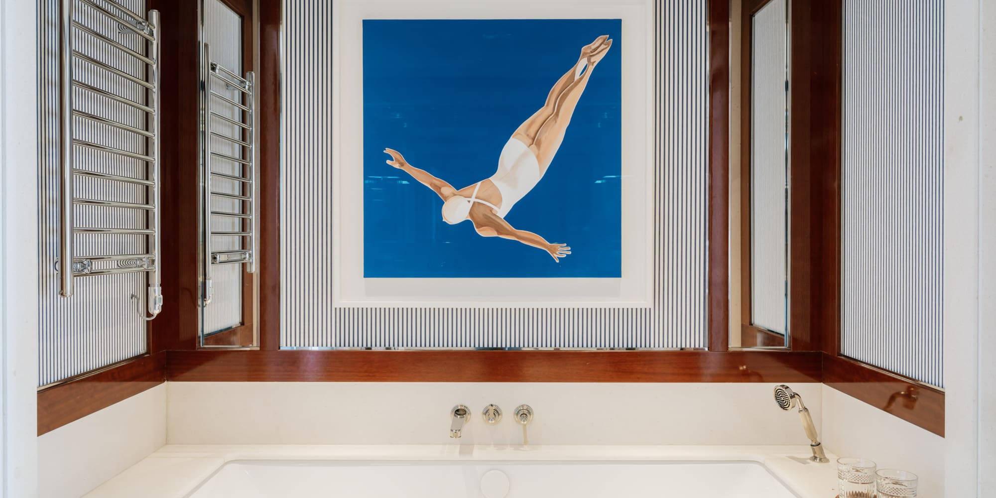 a bathtub and a picture of a woman swimming in the water