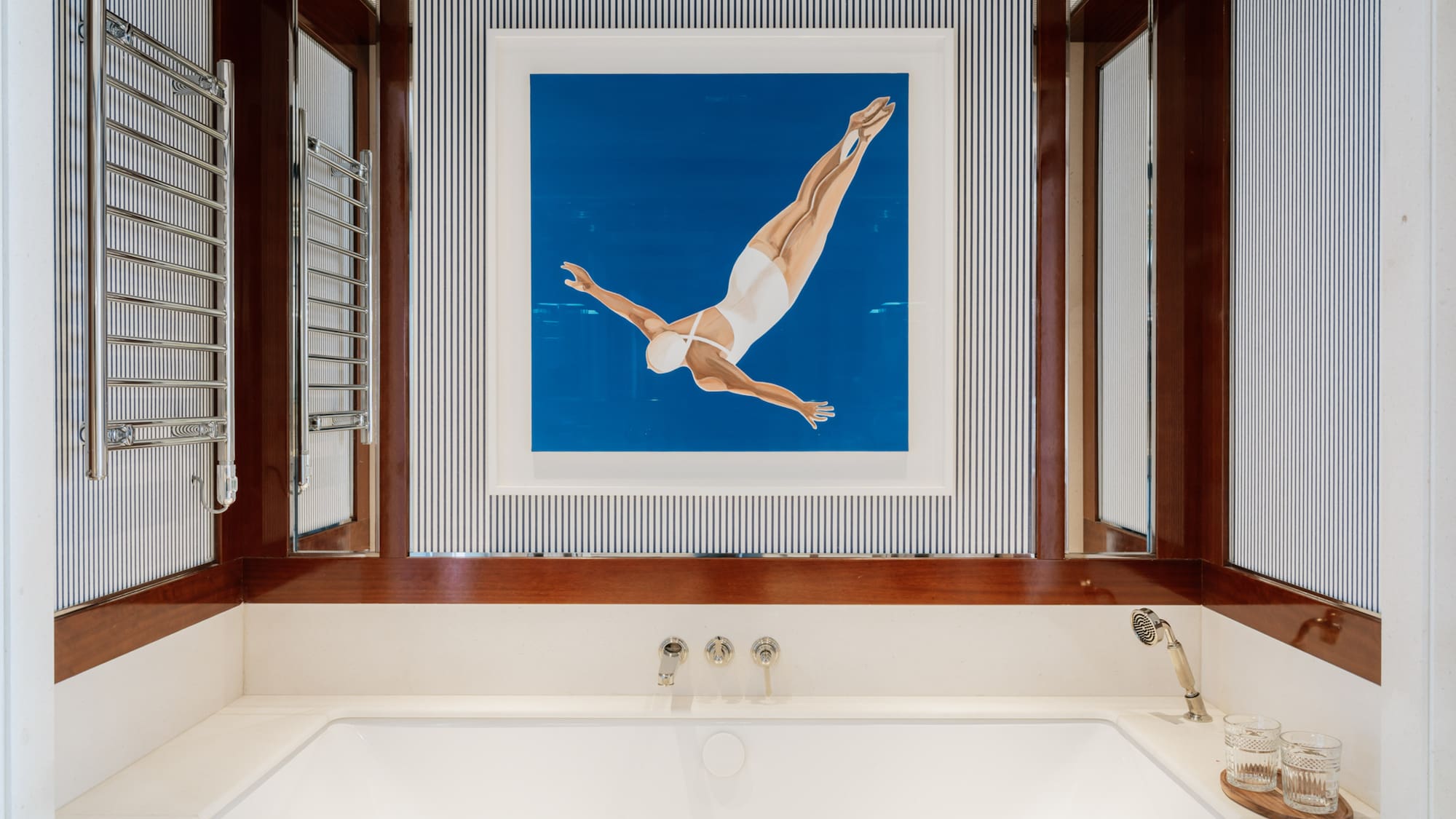 a bathtub and a picture of a woman swimming in the water