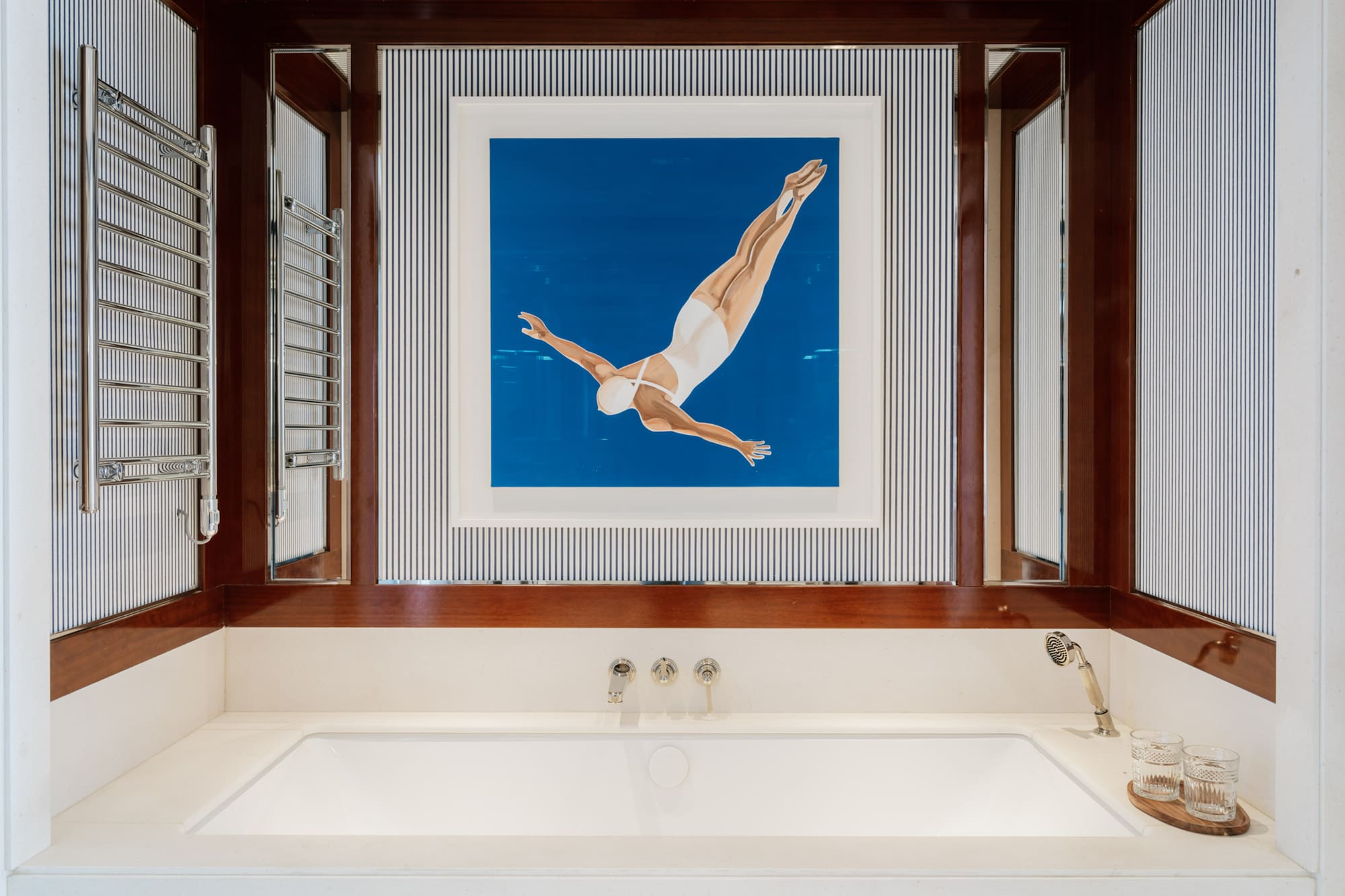 a bathtub and a picture of a woman swimming in the water