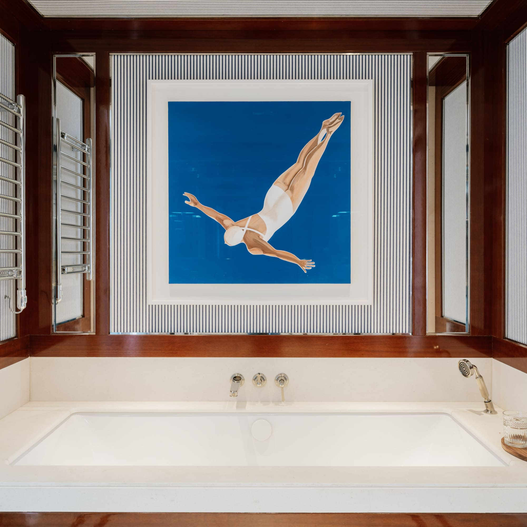 a bathtub and a picture of a woman swimming in the water