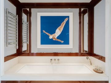 a bathtub and a picture of a woman swimming in the water