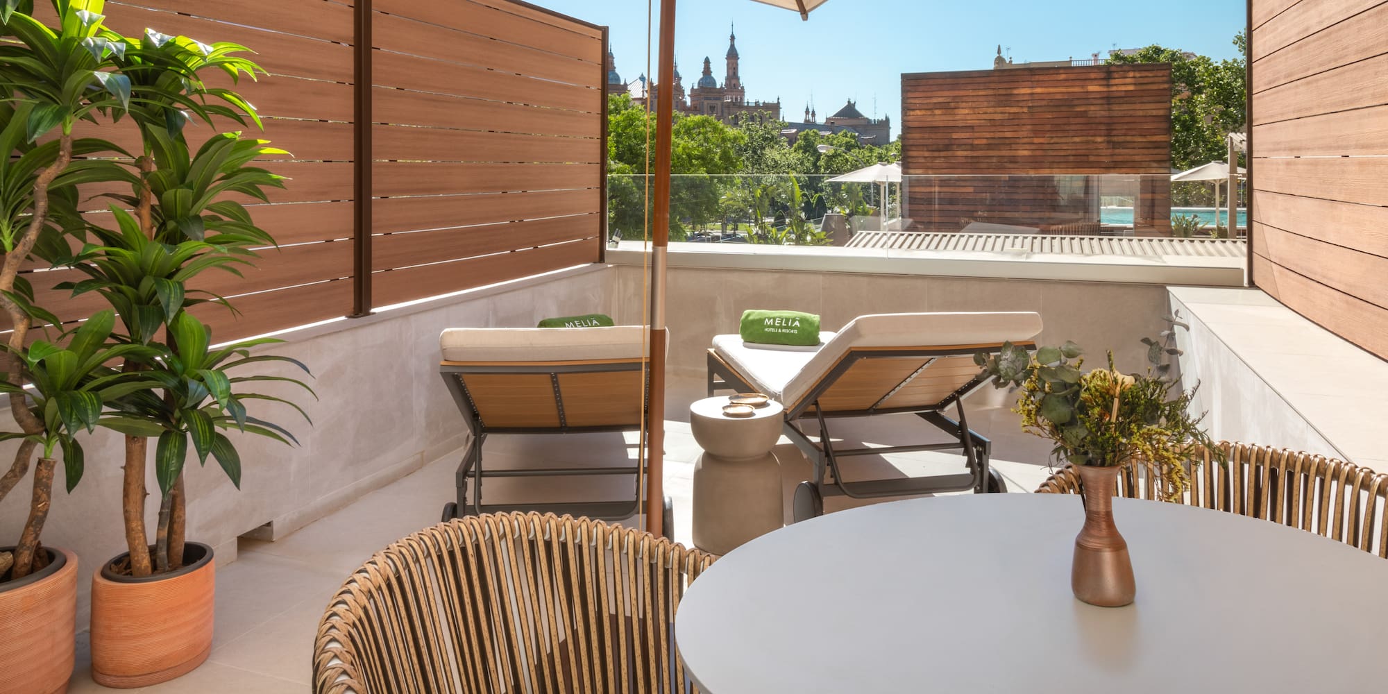 a patio with a table and chairs and a umbrella