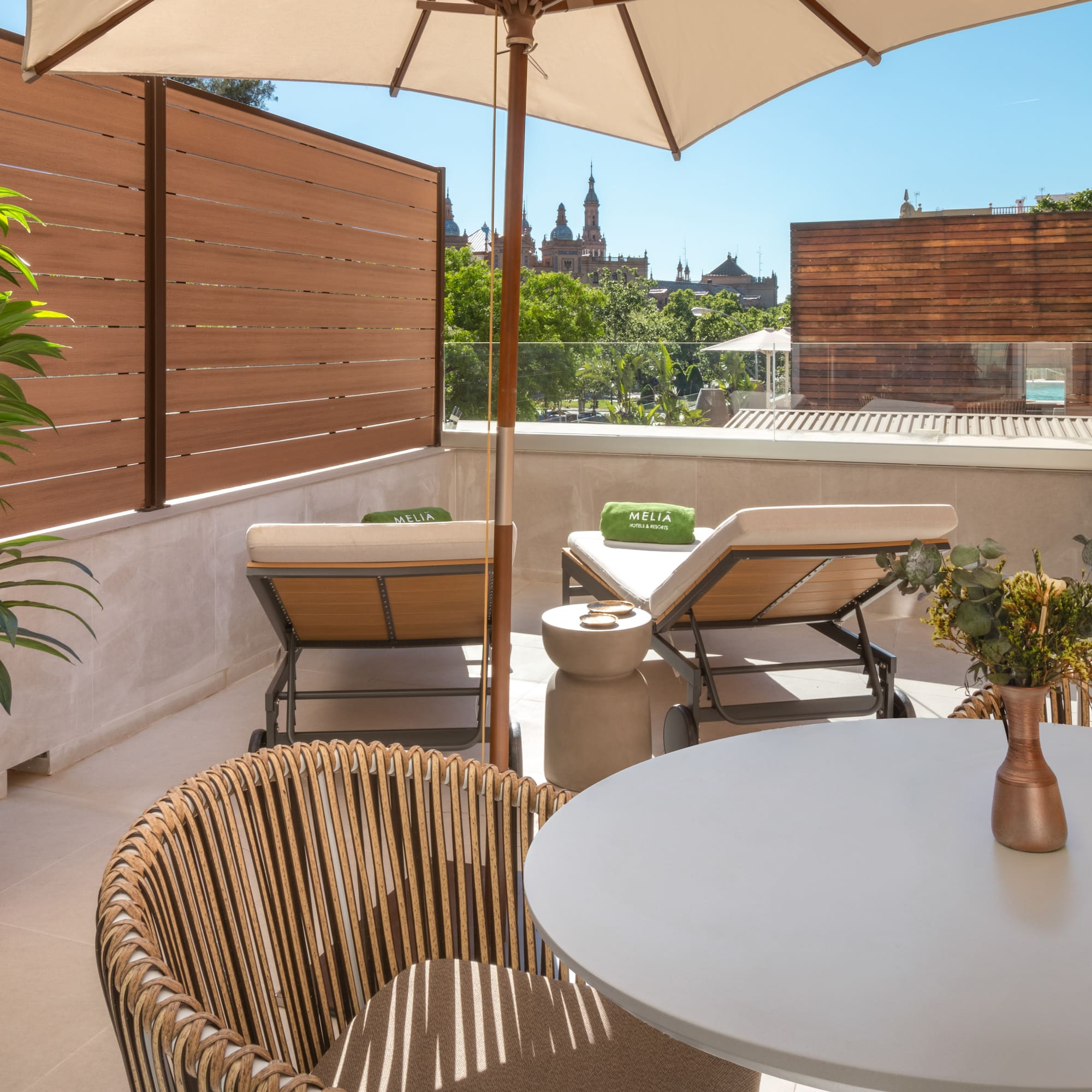 a patio with a table and chairs and a umbrella