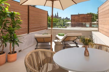 a patio with a table and chairs and a umbrella