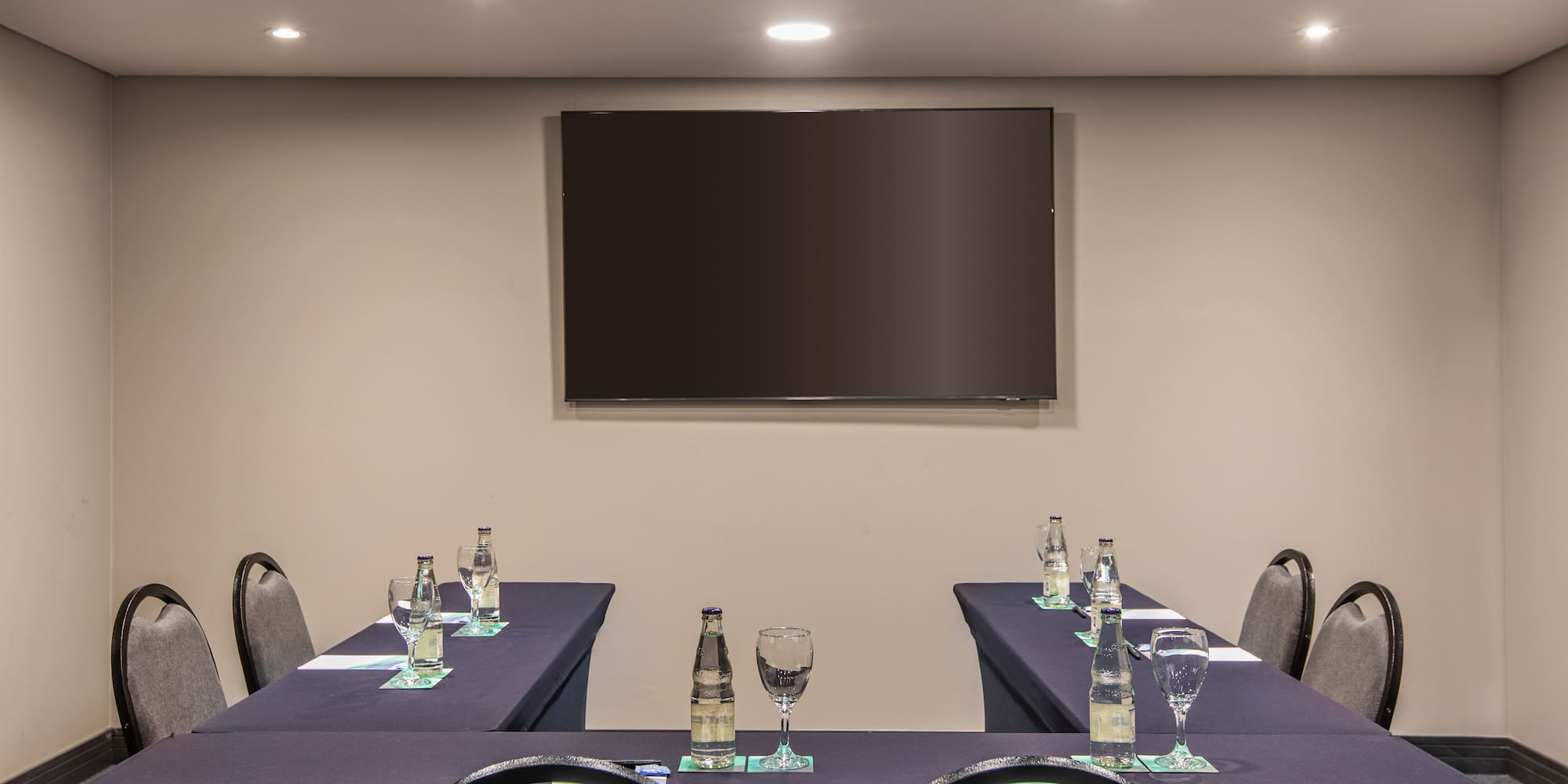 a room with a television and tables