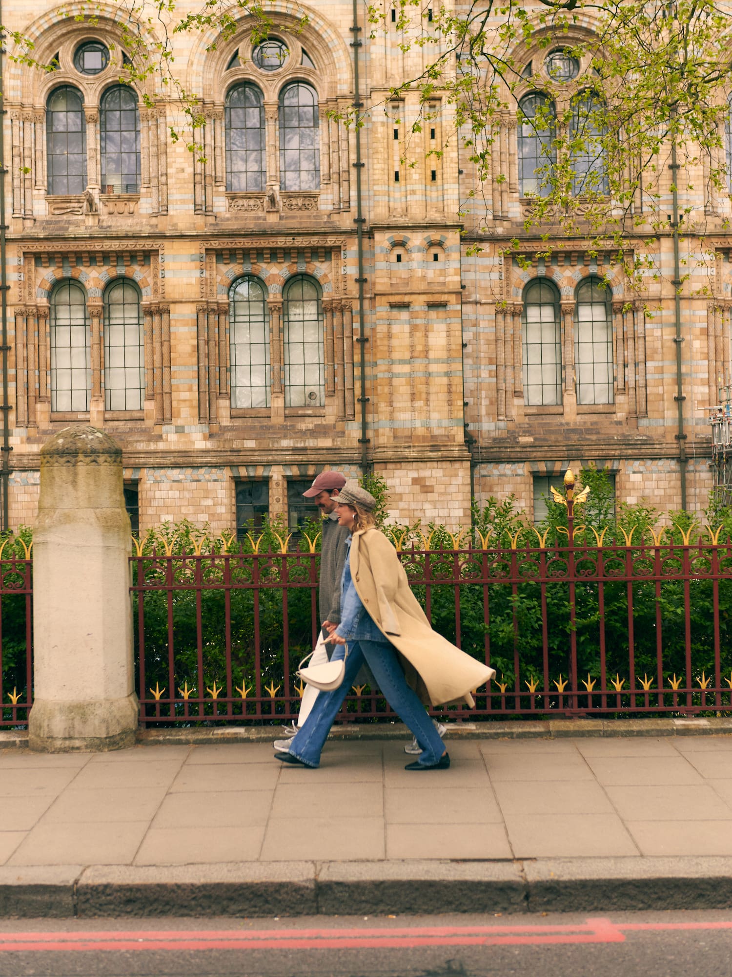 a man and woman walking on a sidewalk