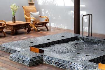 a pool with a wood table and chair