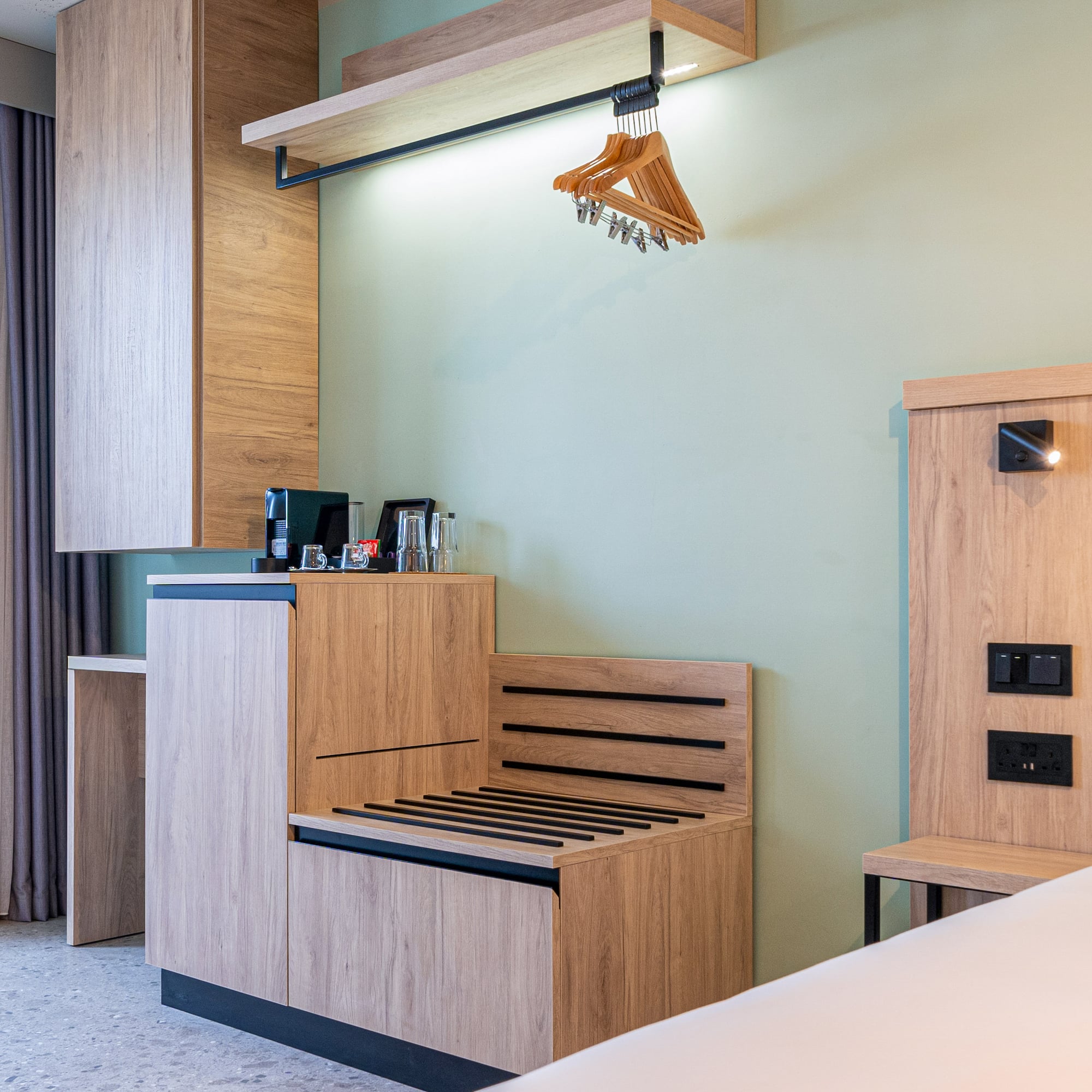 a room with a bench and a bed