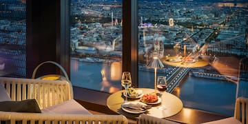 a table with food and wine glasses in front of a window